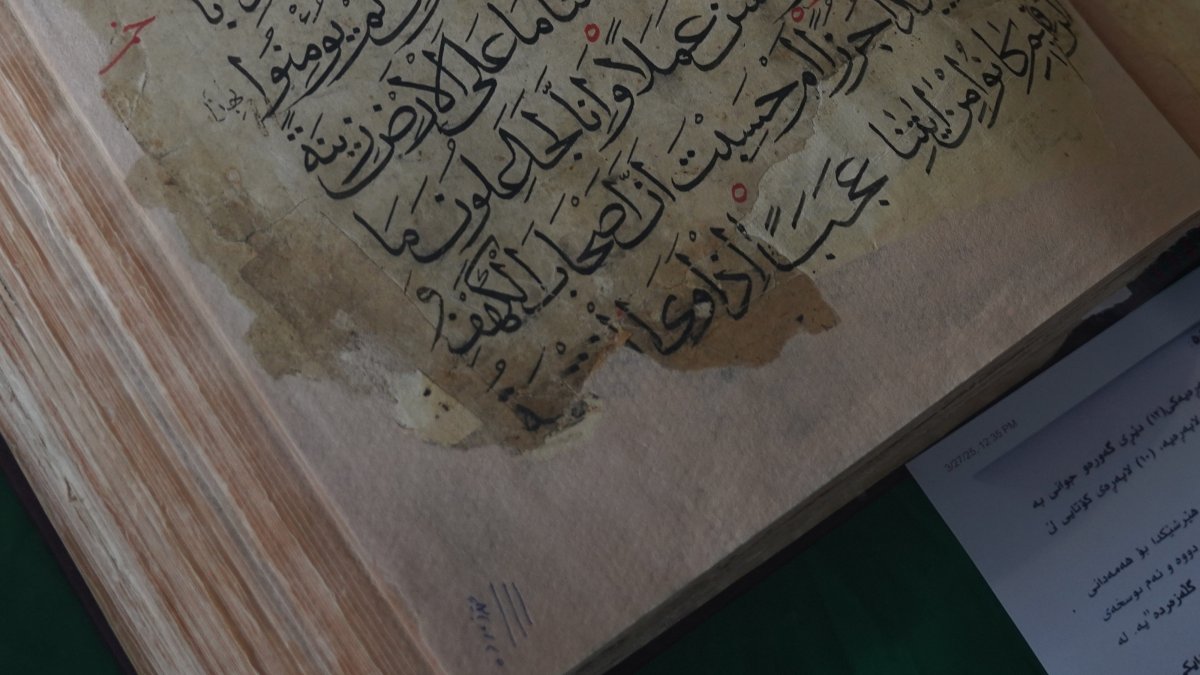 An ancient copy of the Quran is displayed in a glass case, Sulaymaniyah, Iraq, April 4, 2025. (AA Photo)