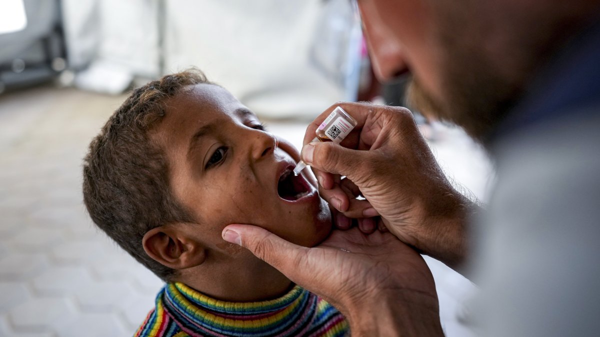 A health worker administers a polio vaccine to a child at a hospital in Deir al-Balah, Gaza Strip, Palestine, Sept. 1, 2024. (AP Photo)