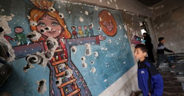 A boy looks at a damaged wall as Palestinians inspect the site of an Israeli airstrike on an UNRWA-run clinic where displaced people shelter, Jabalia, northern Gaza Strip, Palestine, April 2, 2025. (Reuters Photo)