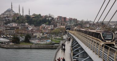 People walk on the Halıç metro bridge, Istanbul, Türkiye, April 1, 2025. (Reuters Photo)