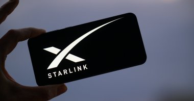 The Starlink logo is displayed on a mobile phone in this photo illustration, Brussels, Belgium, March 23, 2025. (Reuters Photo)