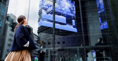 A woman walks past a stock quotation board at a brokerage, Tokyo, Japan, April 7, 2025. (Reuters Photo)