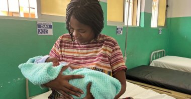 A new mother poses after giving birth to a son in Luanda, Angola, April 30, 2024. (Getty Images)
