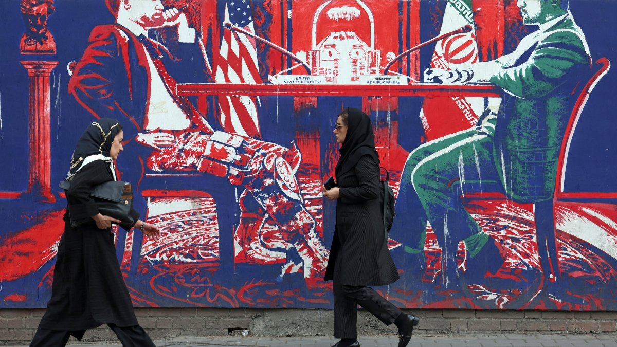 Iranians walk next to an anti-U.S. mural next to the former U.S. Embassy in Tehran, Iran, April 7, 2025. (EPA Photo)
