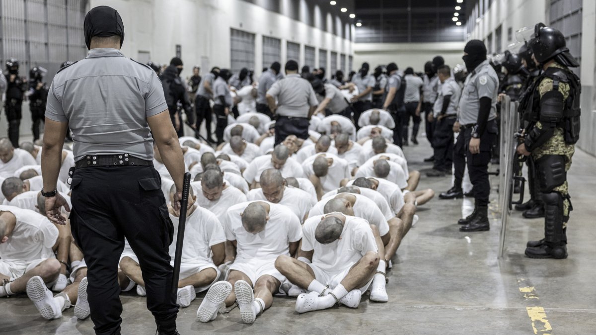 A prison guard transfers deportees from the U.S., alleged to be Venezuelan gang members, to the Terrorism Confinement Center in Tecoluca, El Salvador, March 16, 2025. (AP Photo)
