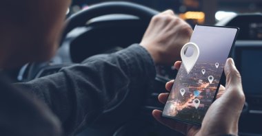 A man uses a smartphone for navigation. (Shutterstock Photo)