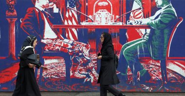 Iranians walk next to an anti-U.S. mural next to the former U.S. Embassy in Tehran, Iran, April 7, 2025. (EPA Photo)