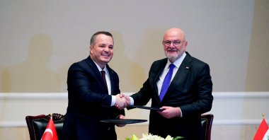 TVF CEO and board member Salim Arda Ermut (L) and DFI Executive Director Mohammed al-Najjar shake hands in a ceremony marking the signing of a memorandum on strategic cooperation, Baghdad, Iraq, April 8, 2025. (AA Photo)