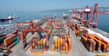 Containers wait to be loaded onto a ship by a heavy-duty crane at a port in Gemlik, Bursa, northwestern Türkiye, March 3, 2023. (Shutterstock Photo)