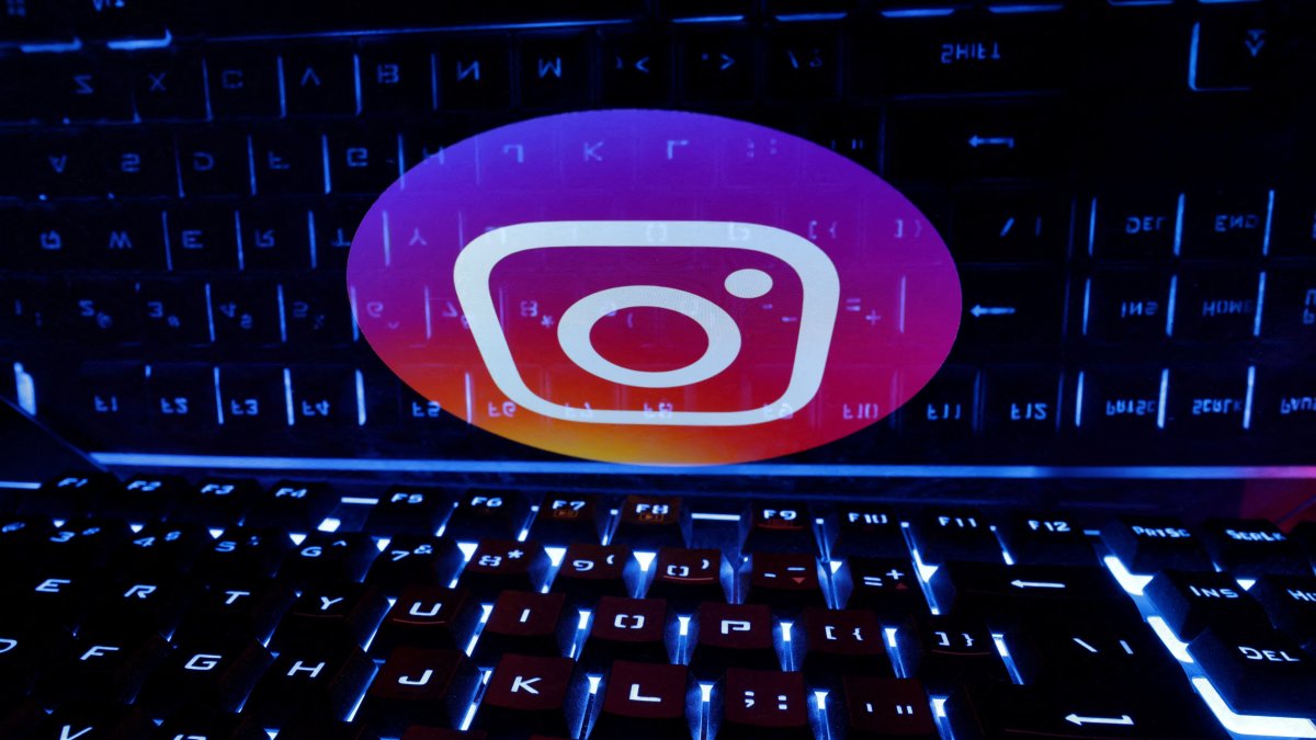 A keyboard is placed in front of a displayed Instagram logo in this illustration taken on Feb. 21, 2023. (Reuters Photo)