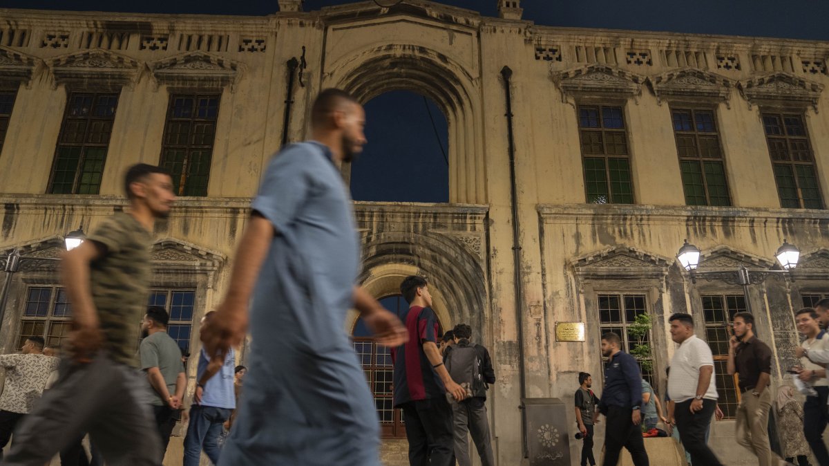 Iraqis walk through the book market in the Mutanabi Street of Baghdad, Iraq, Friday, April 4, 2025. (AP Photo)