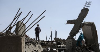 In this file photo, a man inspects a damaged building after a U.S. airstrike in Sana'a, Yemen, April 7, 2025. (EPA Photo)