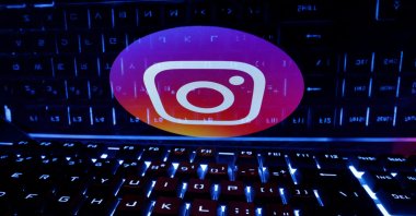 A keyboard is placed in front of a displayed Instagram logo in this illustration taken on Feb. 21, 2023. (Reuters Photo)