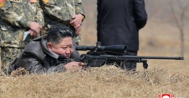 This picture shows North Korean leader Kim Jong Un (C) looking through a rifle scope as he visits a training base of the Korean People&#039;s Army&#039;s special operations forces to observe a comprehensive training session, North Korea, April 5, 2025. (AFP Photo)