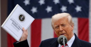 U.S. President Donald Trump holds a "Foreign Trade Barriers" document as he delivers remarks on tariffs in the Rose Garden at the White House, Washington, U.S., April 2, 2025. (Reuters Photo)