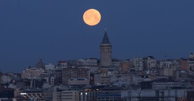 The moon is seen over the Galata Tower, Istanbul, Türkiye, March 14, 2025. (Reuters Photo)