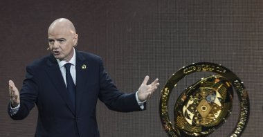 FIFA President Gianni Infantino speaks next to the trophy during the draw for the 2025 FIFA Club World Cup tournament, Miami, U.S., Dec. 5, 2024. (AP Photo)