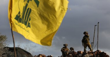 Israeli soldiers stand next to cameras at their new position in front of a Hezbollah flag, near the Lebanese southern border village of Mays al-Jabal, Lebanon, Dec. 13, 2018. (AP Photo)