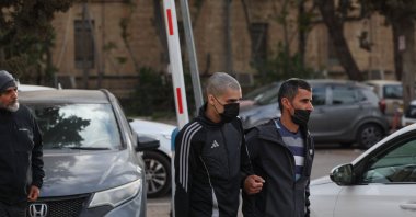 Palestinian Ahmed Manasra (C), released earlier in the day from an Israeli jail, leaves an Israeli security office accompanied by his father in Jerusalem, April 10, 2025. (AFP Photo)
