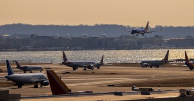 A plane prepares to land as other planes wait on a runway at Ronald Reagan Washington National Airport in Arlington, Virginia, U.S., Feb. 4, 2025. (Reuters Photo)