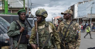 Members of the M23 rebel group stand guard at the opening ceremony of the General Savings Bank of Congo (CADECO), which will serve as the bank for the city of Goma where all banks have closed since the city was taken by the M23 rebels, Goma, North Kivu province, DRC, April 7, 2025. (Reuters Photo)