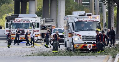 Emergency personnel respond to the area where a small plane crashed on the railroad tracks beneath the overpass near Interstate 95 in Boca Raton, Fla., on Friday, April 11, 2025. (Mike Stocker /South Florida Sun-Sentinel via AP)