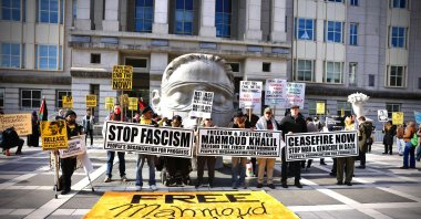 People hold signs as they attend a protest in support of Columbia University student activist Mahmoud Khalil while a hearing takes place outside the court in Newark, New Jersey on March 28, 2025. (AFP File Photo)