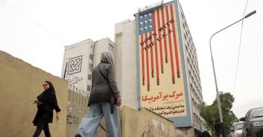 People walk next to an anti-U.S. mural in a street, Tehran, Iran, April 12, 2025. (EPA Photo)