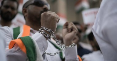 A Congress Party member wears shackles during a protest to condemn the reported mistreatment of Indian immigrants during their deportation from the United States, Hyderabad, India, Feb. 7, 2025. (AP Photo)