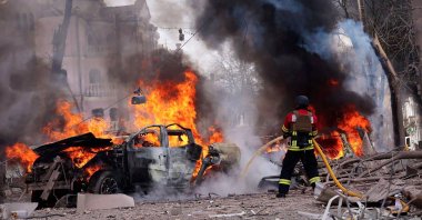 A Ukrainian rescuer works to extinguish a fire at the site of a missile attack in Sumy, northeastern Ukraine, April 13, 2025. (AFP Photo)