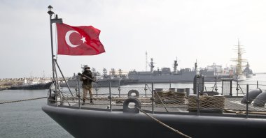 A Turkish marine serviceman stands on the deck of the Turkish naval TCG Turgutreis vessel in the Black Sea port of Constanta, Romania, March 15, 2015. (AP Photo)