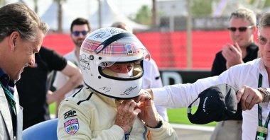 Former British Formula One racing driver Jackie Stewart takes off his helmet after her performed an exhibition lap ahead of the Bahrain Formula One Grand Prix at the Bahrain International Circuit, Sakhir, Bahrain, April 13, 2025. (AFP Photo)