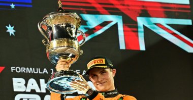 McLaren&#039;s Australian driver Oscar Piastri lifts the trophy on the podium after winning the Bahrain Formula One Grand Prix at the Bahrain International Circuit, Sakhir, Bahrain, April 13, 2025. (AFP Photo)