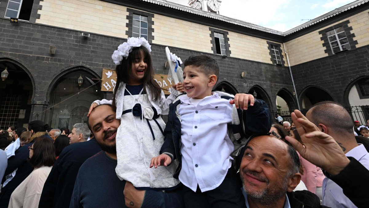 Christian Syrians celebrate Palm Sunday in the yard of the cathedral of Our Lady of Dormition in Damascus, Syria, April 13, 2025. (AFP Photo)