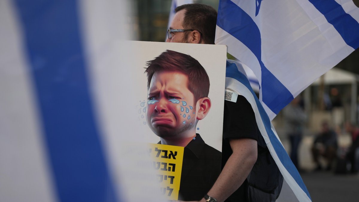 An Israeli protester carries a caricature of PM Benjamin Netanyahu&#039;s son Yair, in Tel Aviv, Israel, April 1, 2023. (AP Photo)