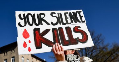 A woman holds a sign as she attends a symbolic funeral procession in solidarity with the people killed in Gaza and the West Bank, Berlin, Germany, April 6, 2025. (EPA Photo)