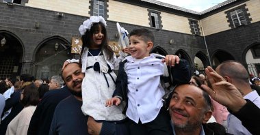 Christian Syrians celebrate Palm Sunday in the yard of the cathedral of Our Lady of Dormition in Damascus, Syria, April 13, 2025. (AFP Photo)