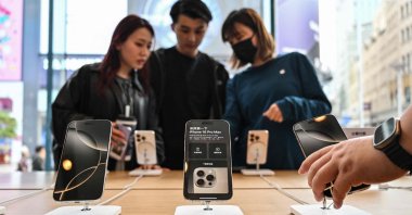 People browse for iPhone 16 displayed in an Apple store in the Huangpu district, Shanghai, China, April 11, 2025. (AFP Photo)