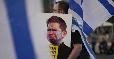 An Israeli protester carries a caricature of PM Benjamin Netanyahu's son Yair, in Tel Aviv, Israel, April 1, 2023. (AP Photo)