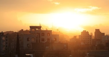 The setting sun's light breaks through a blanket of clouds in the sky over a neighborhood in Sanaa, Yemen, April 13, 2025. (EPA Photo)