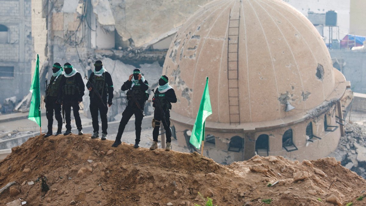 Hamas fighters keep guard on the day Hamas hands over deceased hostages to the Red Cross, as part of a cease-fire and hostages-prisoners swap deal between Hamas and Israel, in Khan Younis in the southern Gaza Strip Feb. 20, 2025. (Reuters File Photo)