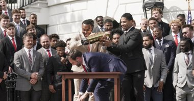 Ohio State University football player TreVeyon Henderson (C-L) catches the top of the team&#039;s championship trophy after U.S. Vice President JD Vance tries to pick it up during a ceremony to honor the Ohio State University Buckeyes football team on their 2025 College Football National Championship on the South Lawn of the White House, Washington, U.S., April 14, 2025. (EPA Photo)