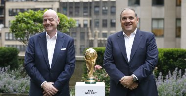 FIFA President Gianni Infantino (L) and CONCACAF President Victor Montagliani stand with the FIFA World Cup trophy, New York, U.S., June 16, 2022. (AP Photo)