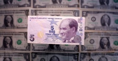 A Turkish lira and U.S. dollar banknotes are seen in this illustration taken March 19, 2025. (Reuters Photo)