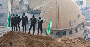Hamas fighters keep guard on the day Hamas hands over deceased hostages to the Red Cross, as part of a cease-fire and hostages-prisoners swap deal between Hamas and Israel, in Khan Younis in the southern Gaza Strip Feb. 20, 2025. (Reuters File Photo)