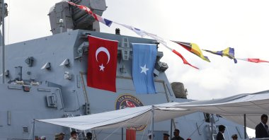 The Somali flag (R) and the Turkish flag are seen above a Turkish warship docked in Mogadishu port after its arrival, more than two months after the signing of a 10-year economic defense agreement, April 23, 2024 (Reuters Photo)