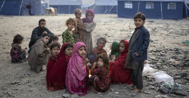 Afghan refugee children warm themselves with fire in a camp in Torkham, Afghanistan, Nov. 4, 2023. (AP Photo)