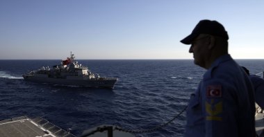 A Turkish officer looks at a naval ship during an annual NATO naval exercise on Türkiye&#039;s western coast on the Mediterranean, Sept. 15, 2022. (AP Photo)
