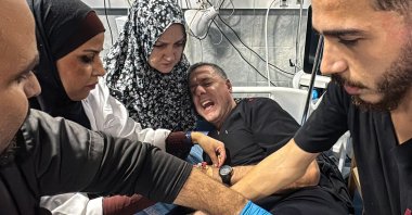 Director of the Kamal Adwan Hospital, Hussam Abu Safiya (C), is treated by colleagues for his injuries following an Israeli strike hit the medical compound in Beit Lahia, northern Gaza, Palestine, Nov. 23, 2024. (AFP Photo)