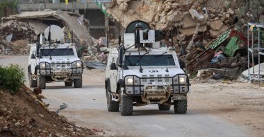 U.N. peacekeepers drive in vehicles past destroyed buildings while patrolling in Kfar Kila, southern Lebanon, April 6, 2025. (AFP Photo)